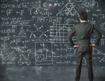 A person looking at a chalkboard with many formulas and numbers. Let's talk about cost estimation and analysis!